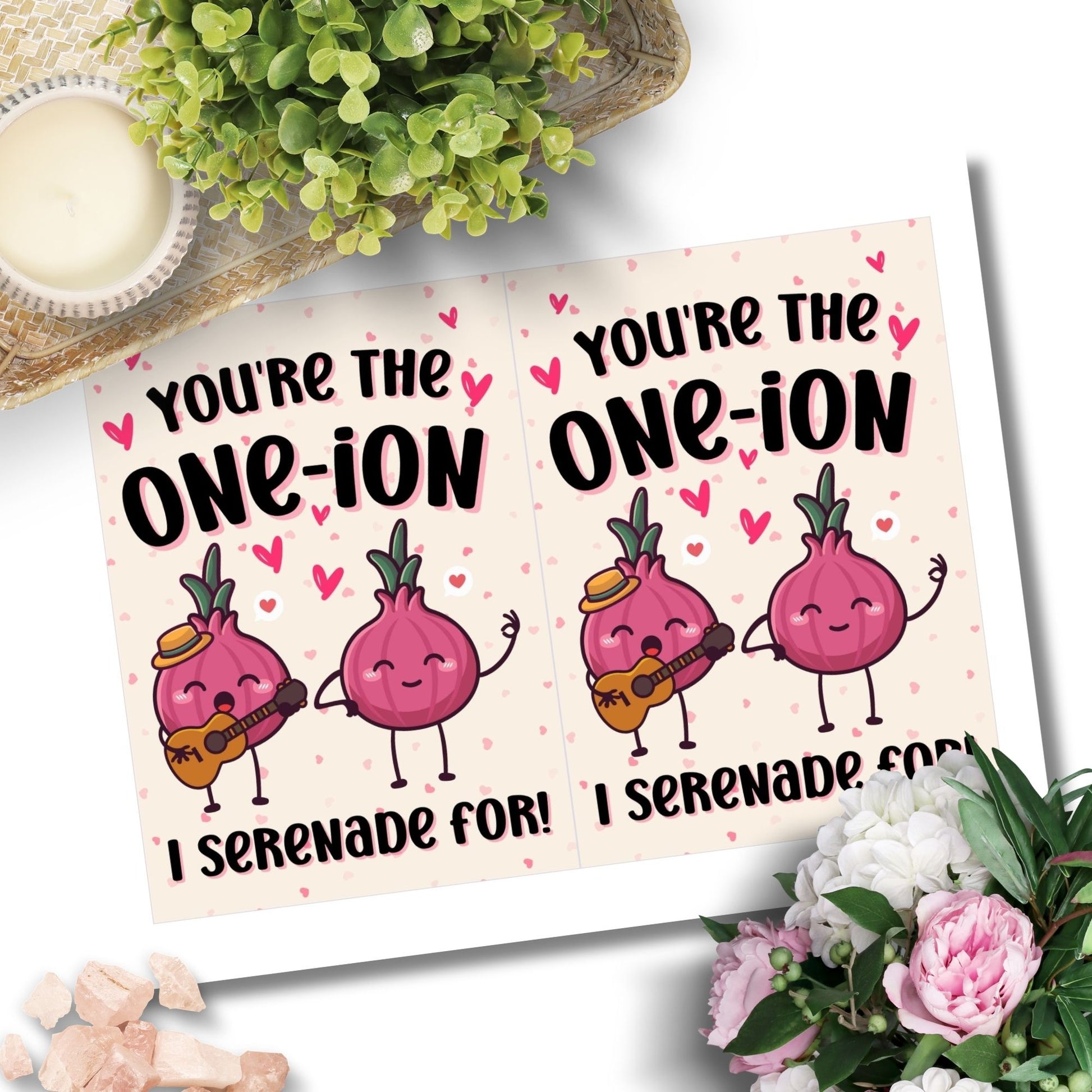 Printable Valentine’s Day Greeting Card featuring the phrase “You’re the One-ion a Serenade For” with a playful onion illustration. Designed as a 5x7 PDF on an 8.5 x 11 sheet with two cards per page. A punny and charming Valentine’s card for loved ones.