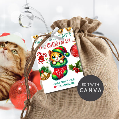 Christmas gift tags featuring a cute kitten snuggled in a festive stocking with holiday decorations like bells, candy canes, and holly, paired with the message "Purr-fectly Wrapped for Christmas!" These printable and editable tags add a cozy, festive touch to holiday gifts.