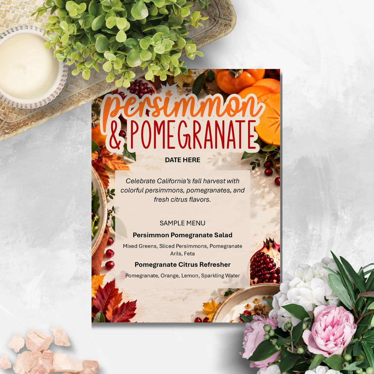A fall harvest themed menu card titled 'persimmon & pomegranate' styled on a light gray marble surface with autumn decorations including pumpkins, fall leaves, and flowers.