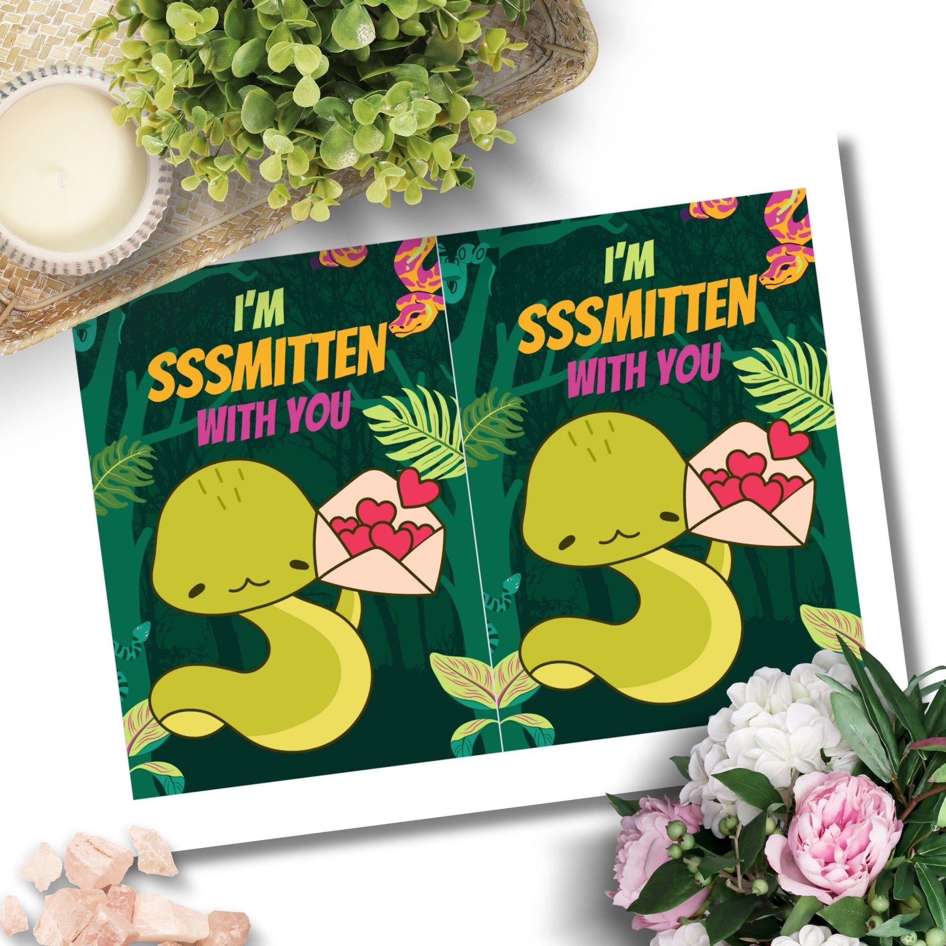 Printable Valentine’s Day Greeting Card featuring the phrase “I'm Sssmitten With You” with a snake theme. Designed as a 5x7 PDF on an 8.5 x 11 sheet with two cards per page. A playful and unique Valentine’s card for snake lovers.