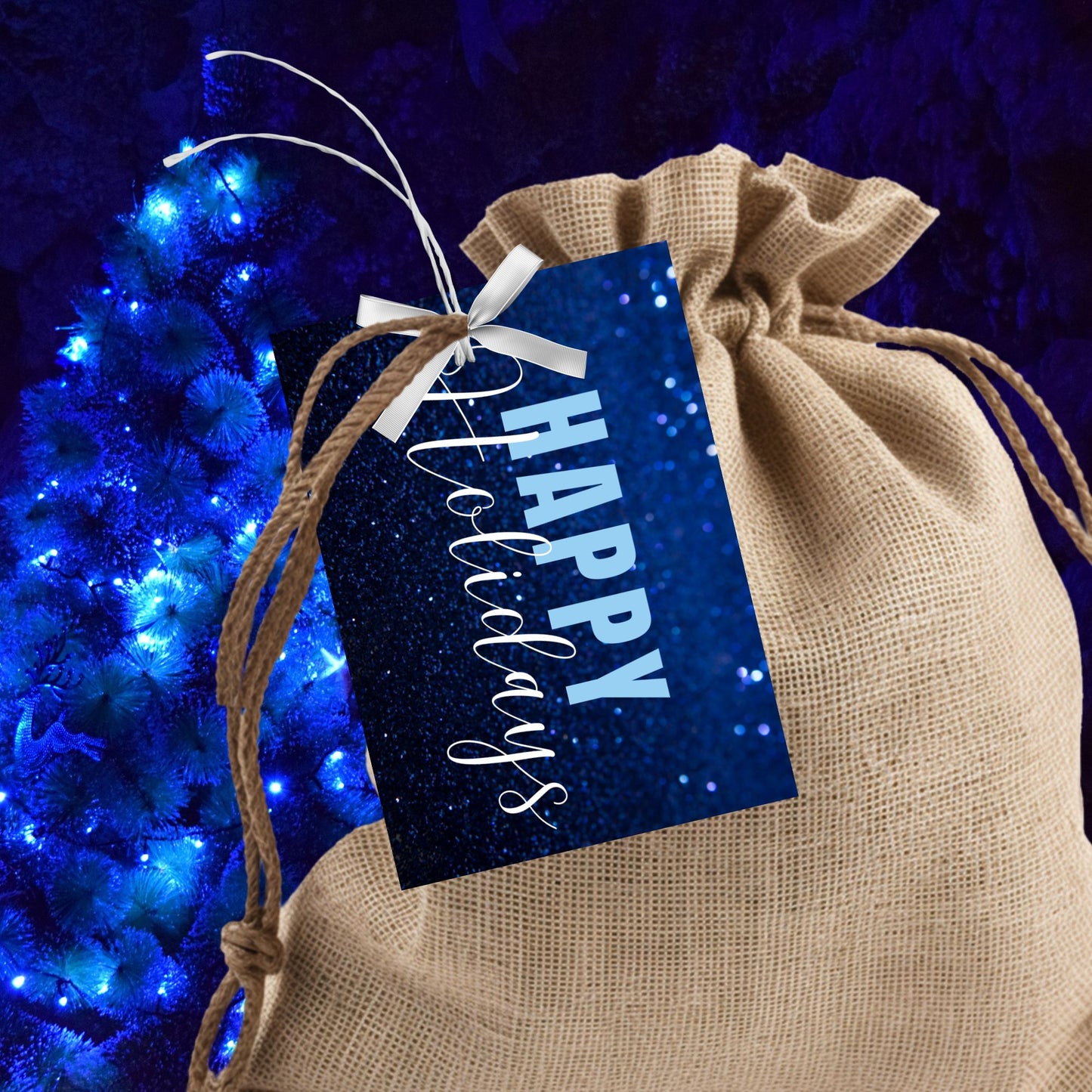 Printable blue Holiday gift tags with a glittery blue background and bold light blue "Happy Holidays" text, sized 2.5 x 3.5 inches, 8 tags per sheet.