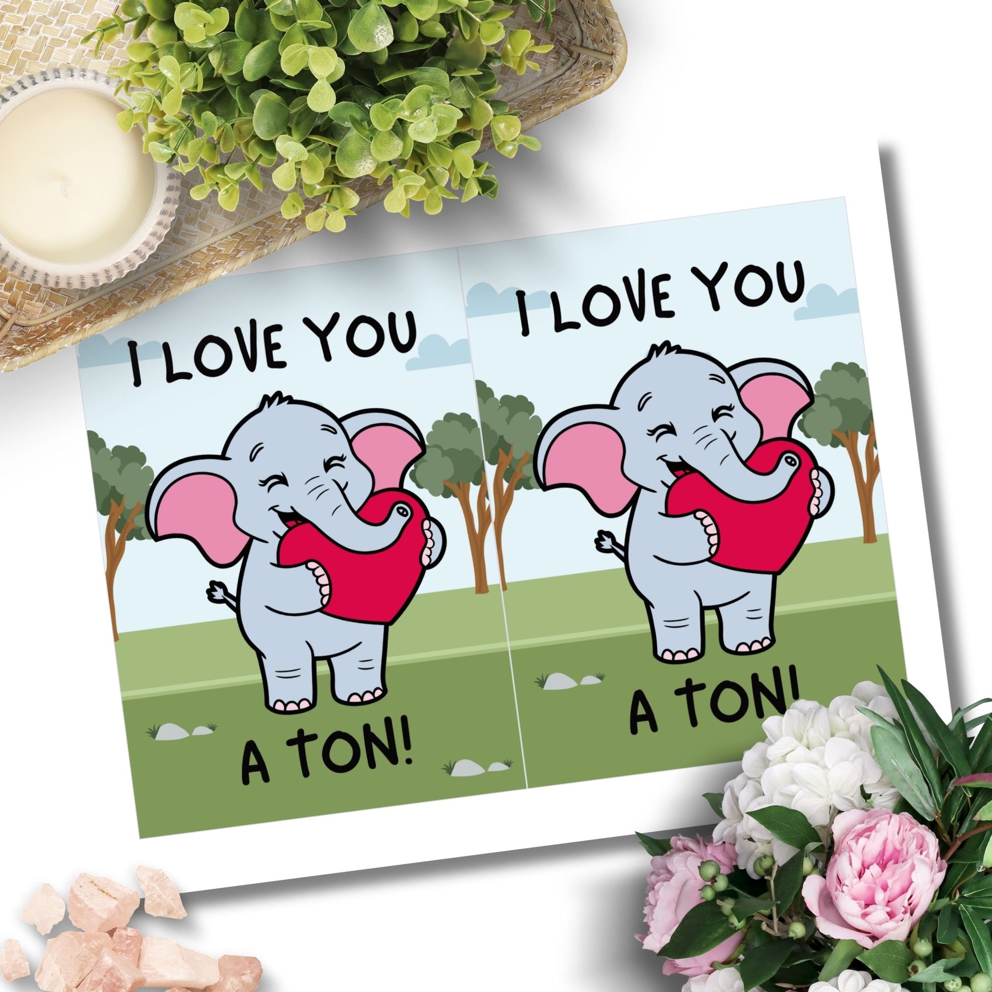 Printable Valentine’s Day Greeting Card featuring the phrase “I Love You a Ton” with an elephant theme. Designed as a 5x7 PDF on an 8.5 x 11 sheet with two cards per page. A cute and heartfelt Valentine’s card for loved ones.