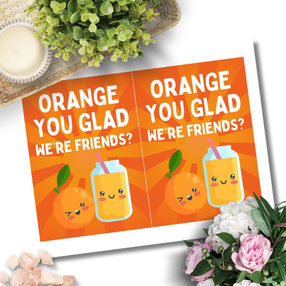 Printable Valentine’s Day Greeting Card featuring the phrase “Orange You Glad We’re Friends” with a cheerful orange theme. Designed as a 5x7 PDF on an 8.5 x 11 sheet with two cards per page. A fun and sweet Valentine’s card for friends.