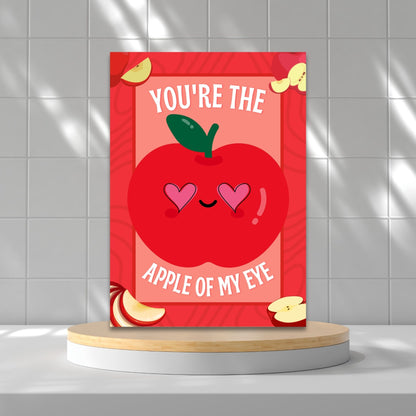 Printable Valentine’s Day Greeting Card featuring the phrase “You’re the Apple of My Eye” with an apple design. Designed as a 5x7 PDF on an 8.5 x 11 sheet with two cards per page. A sweet and timeless Valentine’s card for loved ones.