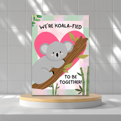 Printable Valentine’s Day Greeting Card featuring the phrase “We’re Koalafied to Be Together” with a koala design. Designed as a 5x7 PDF on an 8.5 x 11 sheet with two cards per page. A cute and punny Valentine’s card for loved ones.