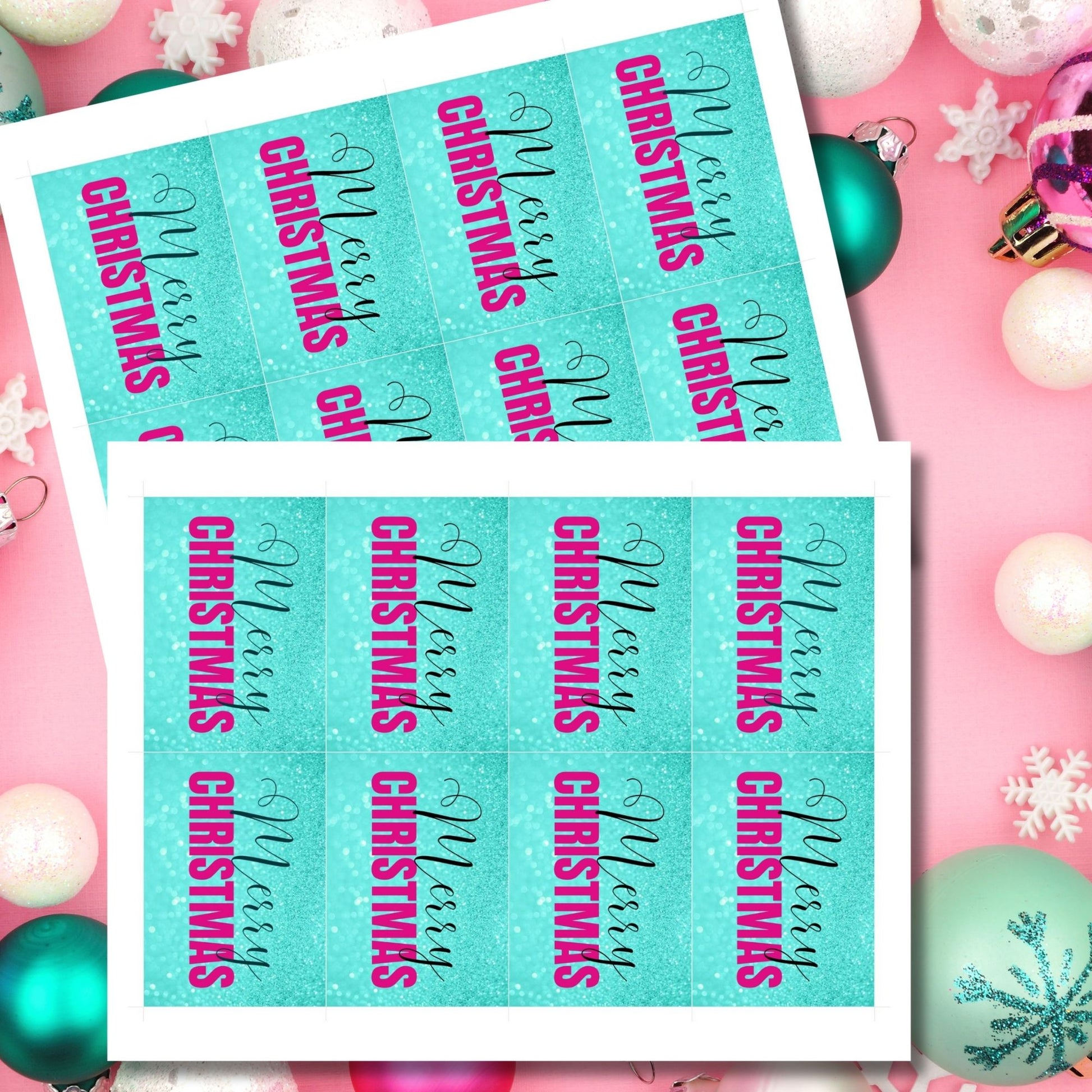 Printable Christmas gift tags featuring an aqua glitter background with bold magenta "Merry Christmas" text and black script accents, sized 2.5 x 3.5 inches, 8 tags per sheet.