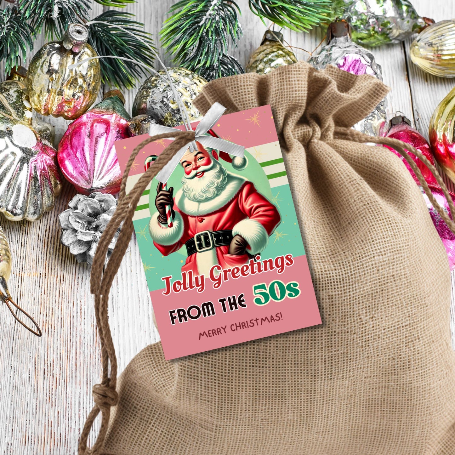 Retro-inspired Christmas gift tags featuring a vintage Santa holding a candy cane, with the text "Jolly Greetings from the 50s." These printable and editable tags evoke a nostalgic holiday vibe, perfect for adding a classic touch to Christmas gifts.