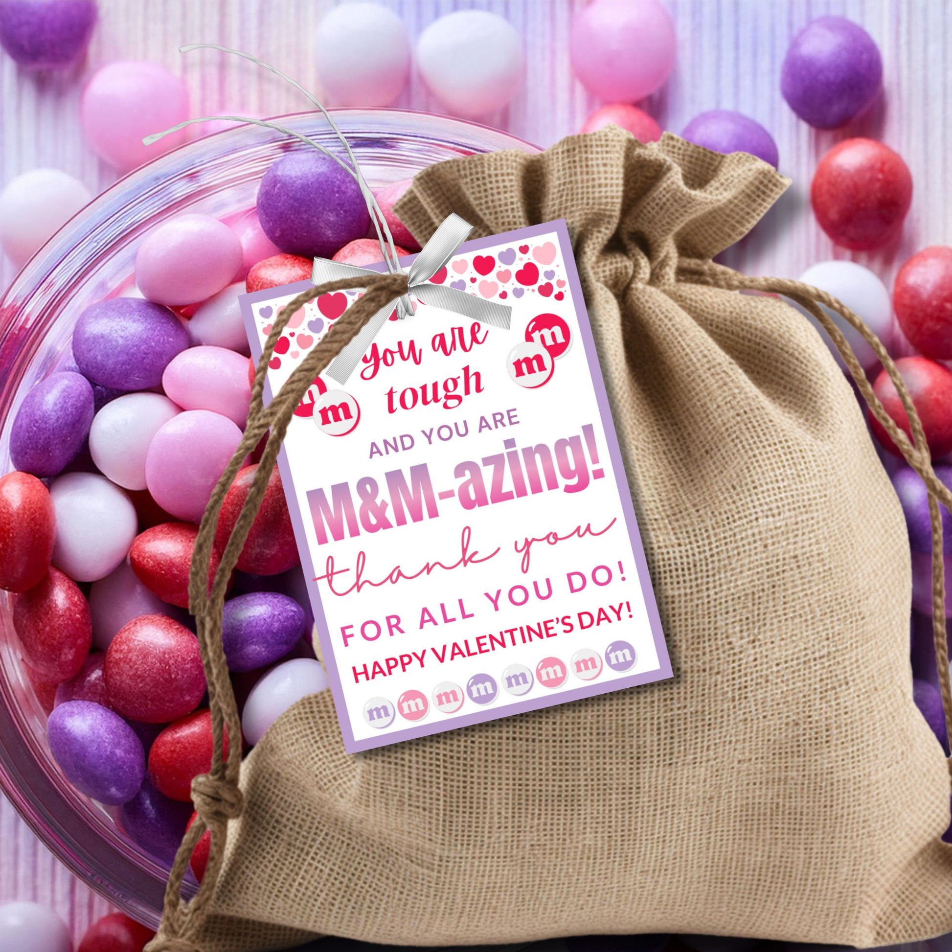Printable and editable M&M-themed appreciation gift tags with the message "Teaching is tough, but you’re M&M-azing!" Buyers can customize the word "teaching" to fit different professions. Perfect for attaching to M&Ms or sweet treats.