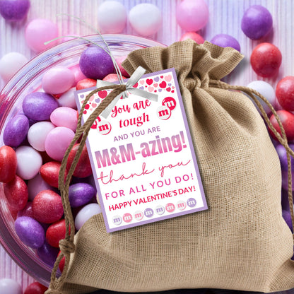 Printable and editable M&M-themed appreciation gift tags with the message "Teaching is tough, but you’re M&M-azing!" Buyers can customize the word "teaching" to fit different professions. Perfect for attaching to M&Ms or sweet treats.