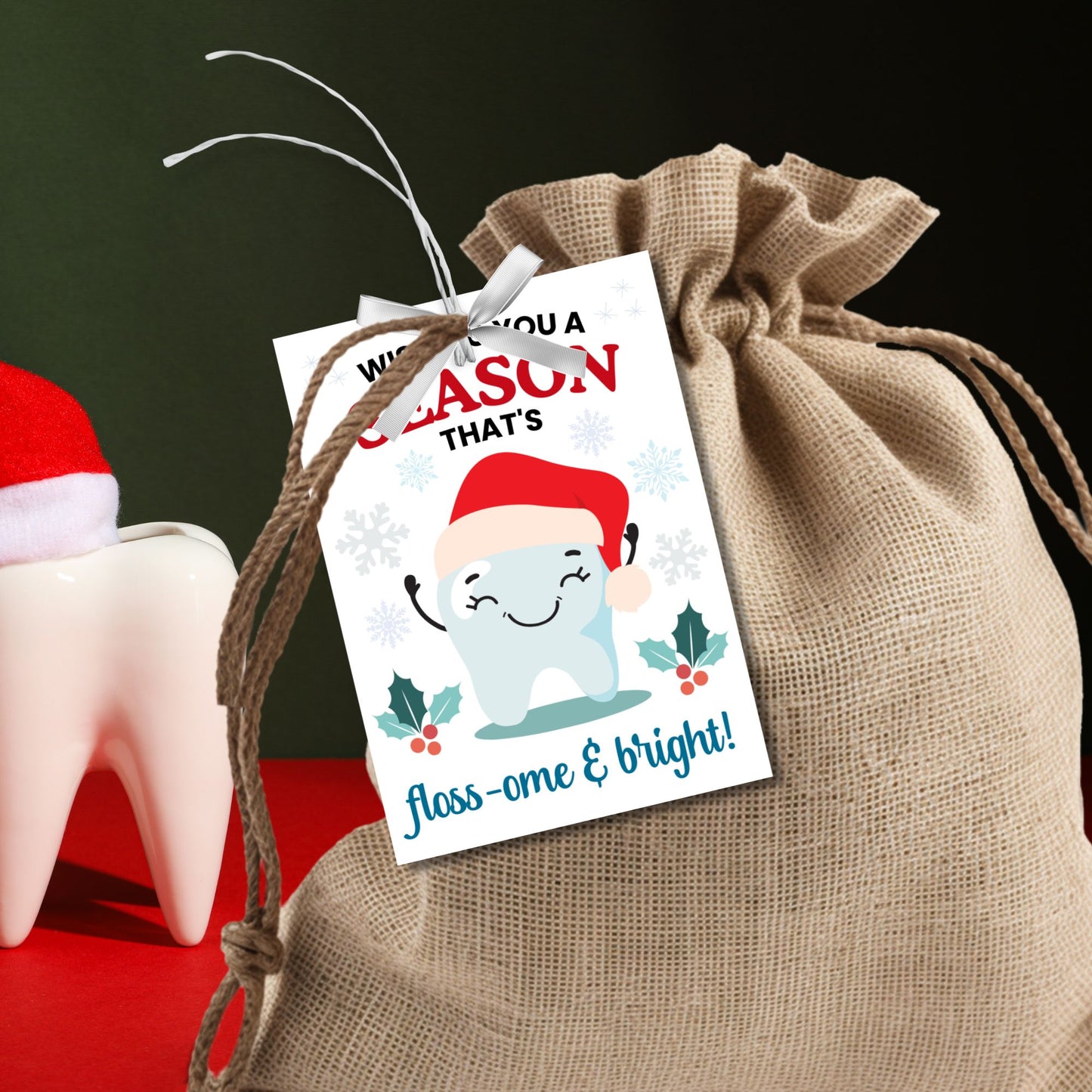 A set of 8 printable and editable holiday gift tags with the message 'Wishing You a Season That's Floss-ome & Bright!' featuring a cheerful tooth character wearing a Santa hat, surrounded by snowflakes, holly, and festive decorations. Perfect for dentists, dental office staff, and dental-themed holiday gifts.