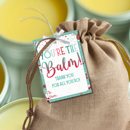 Christmas gift tags featuring the message "You're the Balm!" with a festive design, perfect for lip balm or body balm gifts. These printable and editable tags add a unique, heartfelt touch to holiday appreciation gifts.