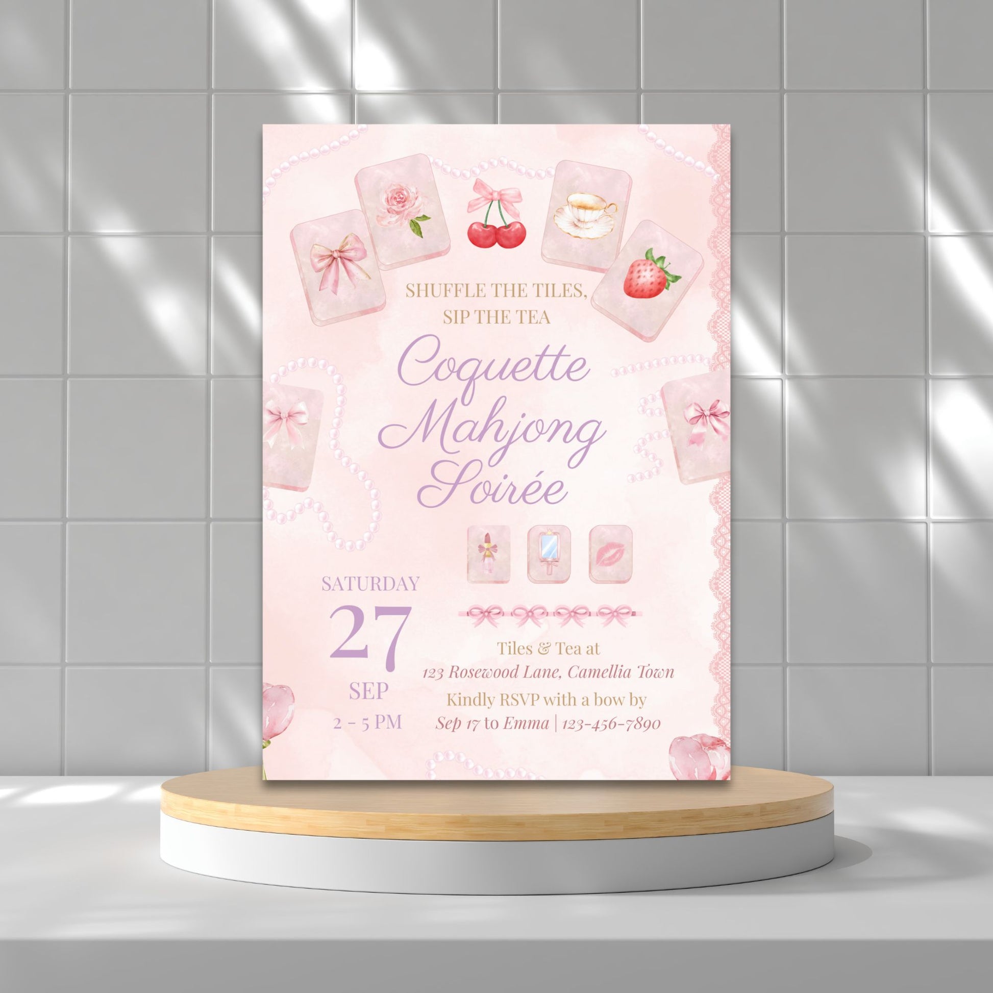 Pink event invitation card on a round wooden platform with a tiled wall background