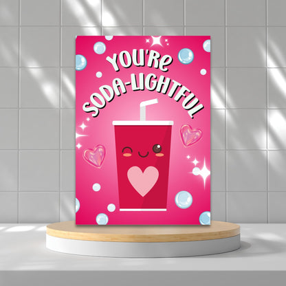 Printable Valentine’s Day Greeting Card featuring the phrase “You’re Soda-lightful” with a soda bottle illustration. Designed as a 5x7 PDF on an 8.5 x 11 sheet with two cards per page. A bubbly and pun-filled Valentine’s card for loved ones.