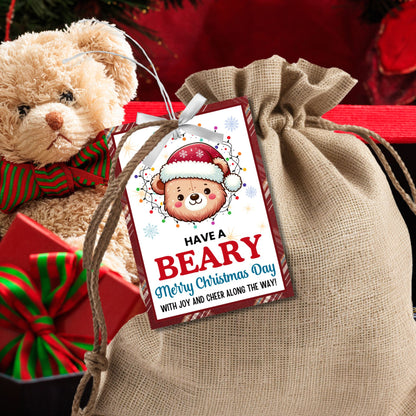 Cute bear-themed holiday gift tags featuring an adorable bear wearing a Santa hat and wrapped in Christmas lights, with the message 'Have a Beary Merry Christmas Day with joy and cheer along the way!' Perfect for personalized holiday gifts.