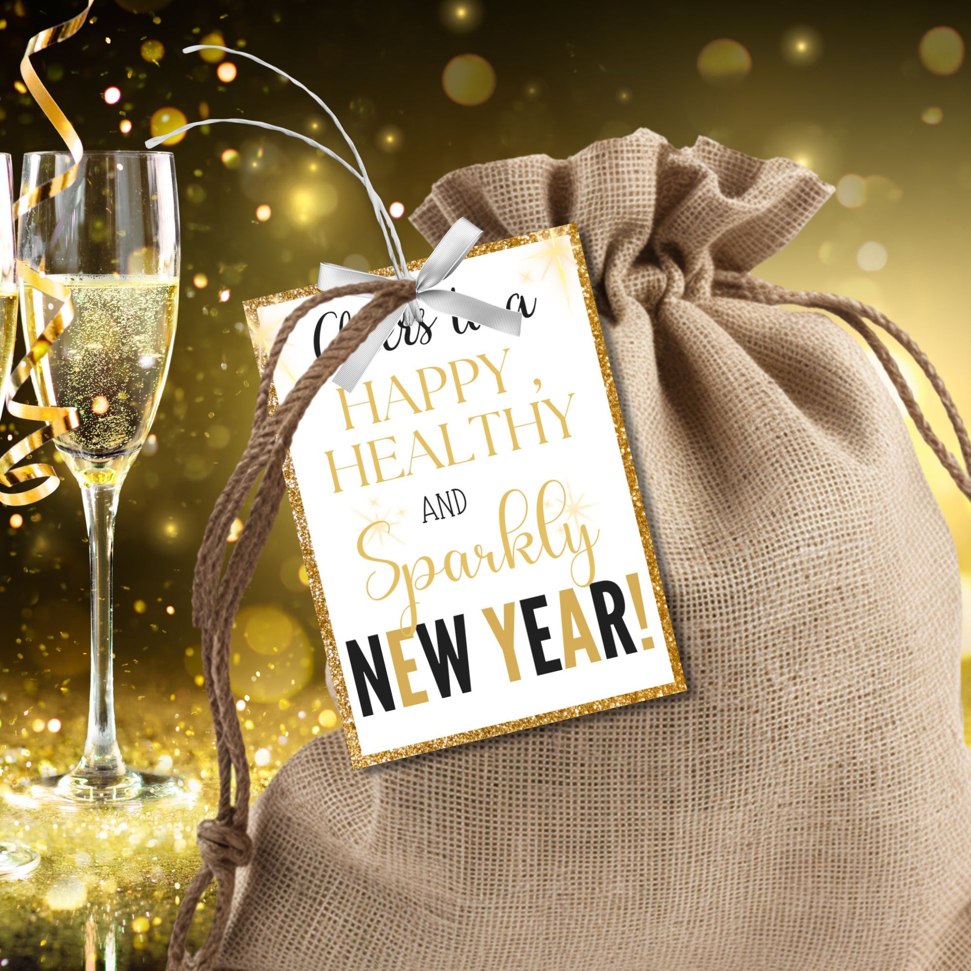 Gold and glittery editable printable New Year gift tags reading “Cheers to a Happy, Healthy, and Sparkly New Year!” laid out on an 8.5 x 11 sheet with 8 tags.