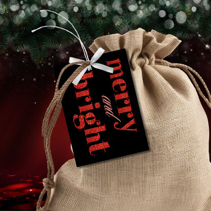 A set of ready-to-print Christmas gift tags featuring striking red glitter text on a black background with festive messages like "Merry and Bright" and "Season's Greetings." Each tag is sized at 2.5 x 3.5 inches, perfect for bold and festive holiday gifting.