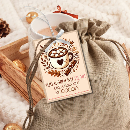 Editable hot cocoa-themed fall gift tags with the message 'You Warm My Heart Like a Cozy Cup of Cocoa' in 2.5 x 3.5 inches, 8 per sheet, available as printable and customizable PDFs.