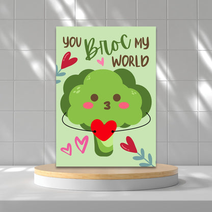 Printable Valentine’s Day Greeting Card featuring the phrase “You Broc My World” with a fun broccoli design. Designed as a 5x7 PDF on an 8.5 x 11 sheet with two cards per page. A punny and veggie-themed Valentine’s card for loved ones.