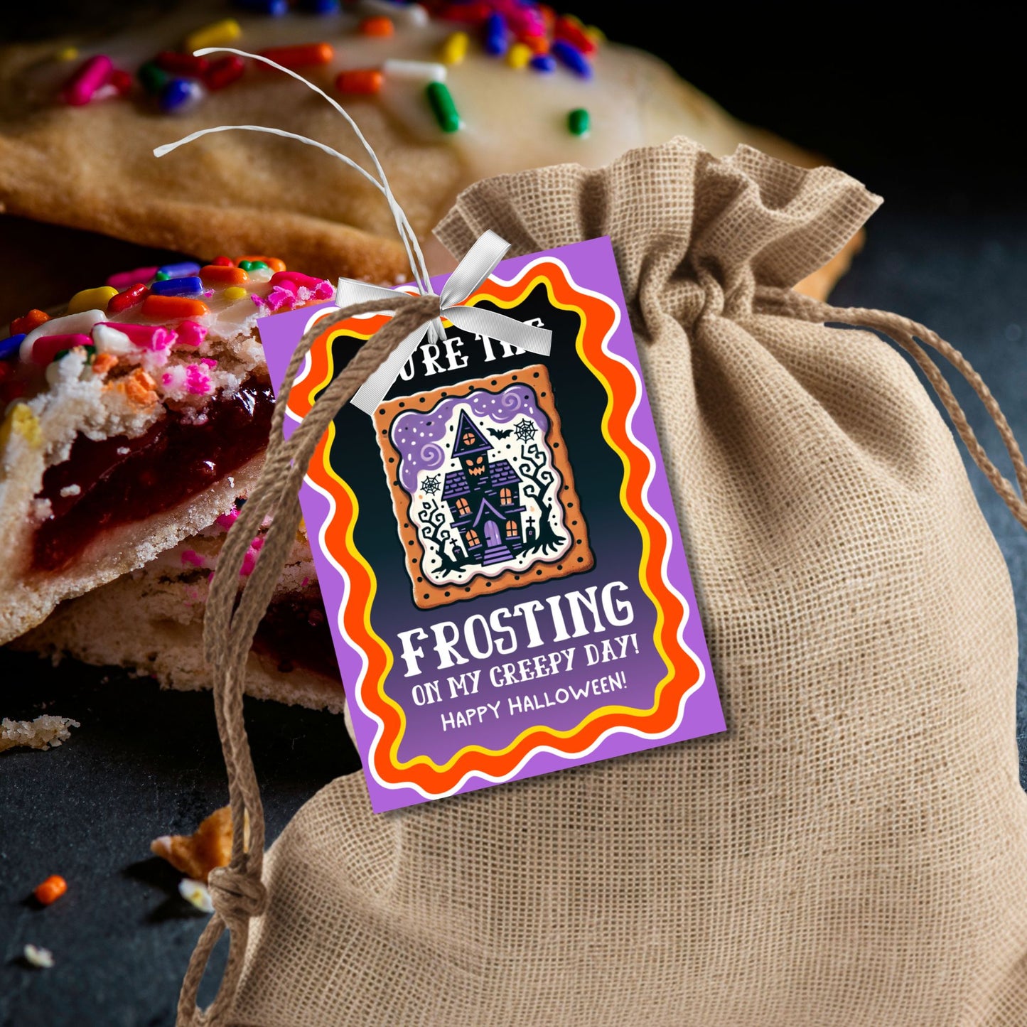 Colorful Halloween Pop-Tart-themed gift tag with a haunted house design and the message 'You're the Frosting on My Creepy Day!' Perfect for spooky treat bags.