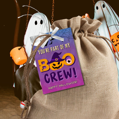 Halloween-themed gift bag with ghost decorations and a purple tag.