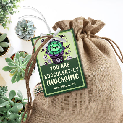 Halloween-themed printable gift tags with the message "You Are Succulent-ly Awesome" featuring a cute succulent plant surrounded by spooky Halloween icons. Tags are 2.5 x 3.5 inches, laid out 8 per sheet on a standard 8.5 x 11-inch page. Includes a printable PDF and a PDF with a link to an editable Canva template.