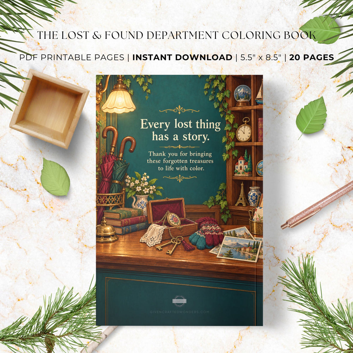 A digital coloring book cover mockup for 'The Lost & Found Department Coloring Book' displayed on a white marble background with decorative leaves, pine branches, a wooden tray, and a pencil. The cover features a dark teal background with a vintage desk scene and the text 'Every lost thing has a story.