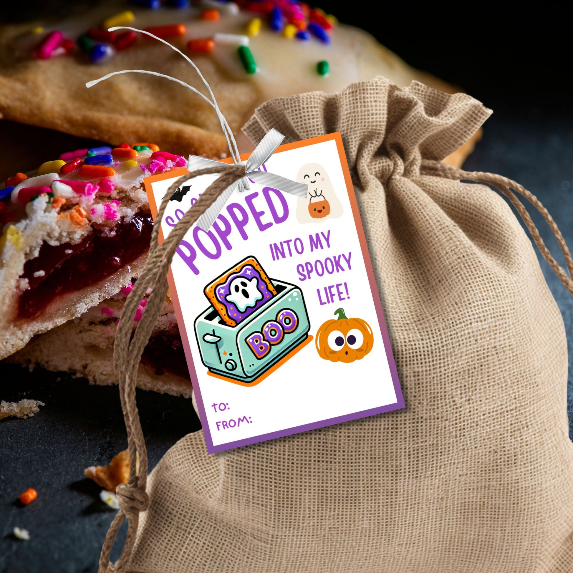 Halloween gift tag featuring a toaster with Pop-Tarts and ghosts with the message 'So Glad You Popped into My Spooky Life!' for Halloween Pop-Tart gifts. Perfect for printable and editable Halloween treat tags.