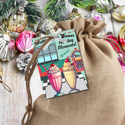 Retro-inspired Christmas gift tags featuring a 1950s diner scene with a jukebox, booths, and milkshakes, paired with the message "Wishing You Sweet Holiday Moments!" These printable and editable tags add a nostalgic touch to holiday gifting.