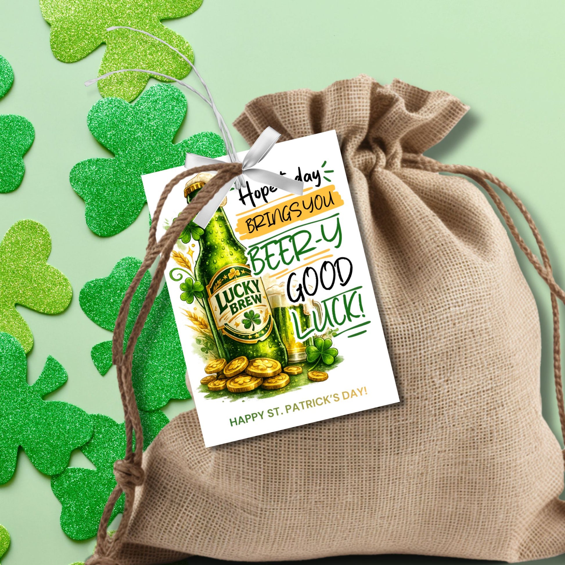 St. Patrick’s Day printable gift tag featuring a green beer-inspired drink with the phrase “Hope Today Brings You Beery Good Luck.” The festive design includes shamrocks and lucky elements. Tags are sized 2.5 x 3.5 inches, arranged 8 per 8.5 x 11 printable sheet, and available as a printable PDF and editable Canva template.