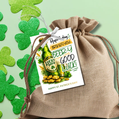 St. Patrick’s Day printable gift tag featuring a green beer-inspired drink with the phrase “Hope Today Brings You Beery Good Luck.” The festive design includes shamrocks and lucky elements. Tags are sized 2.5 x 3.5 inches, arranged 8 per 8.5 x 11 printable sheet, and available as a printable PDF and editable Canva template.