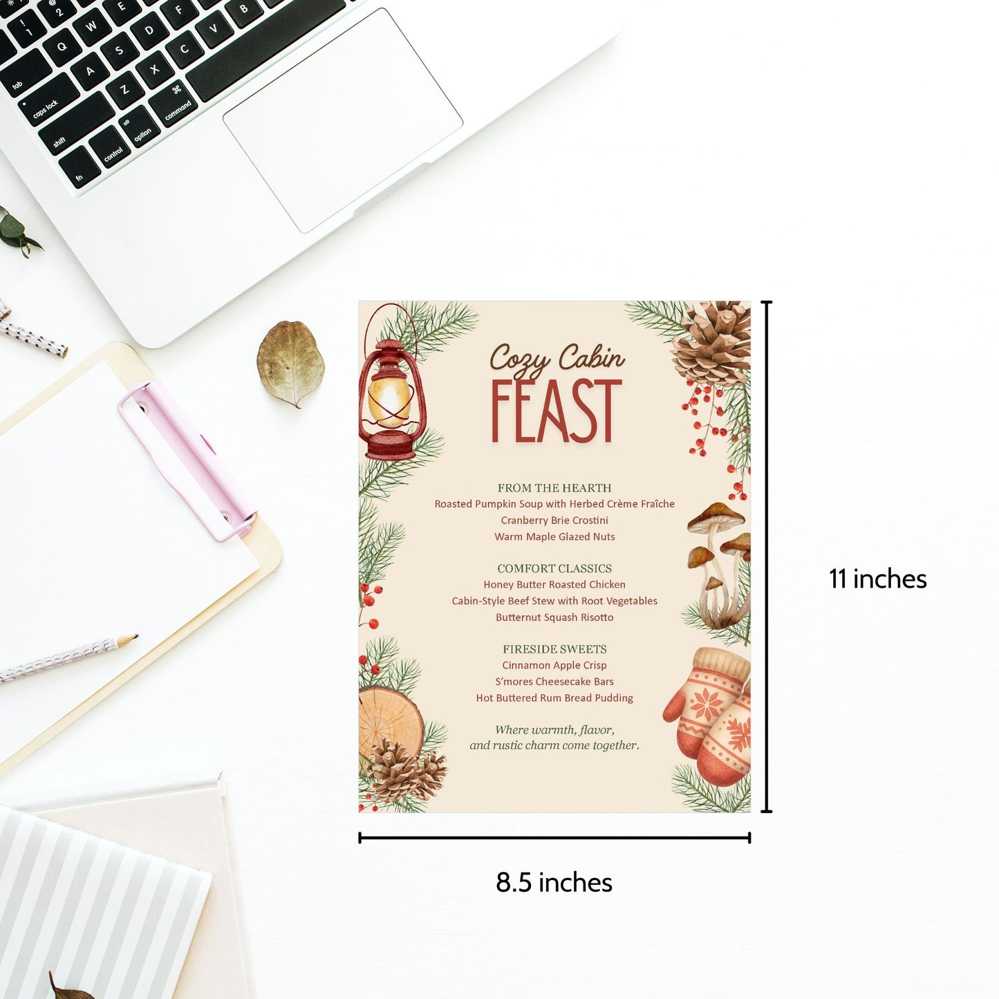 Menu card titled 'Cozy Cabin Feast' with dimensions labeled on a desk with a laptop.