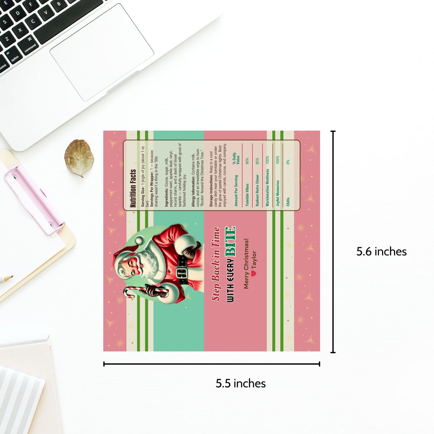 Rectangular product with Santa Claus design and text, placed on a desk with a laptop and pen.