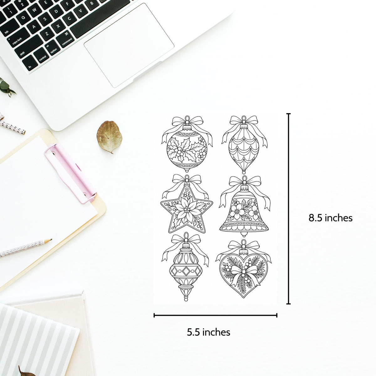 A flat-lay of six black line-art Christmas ornament and bell designs on a white sheet, with dimension markers showing 8.5 inches tall by 5.