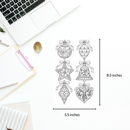 A flat-lay of six black line-art Christmas ornament and bell designs on a white sheet, with dimension markers showing 8.5 inches tall by 5.