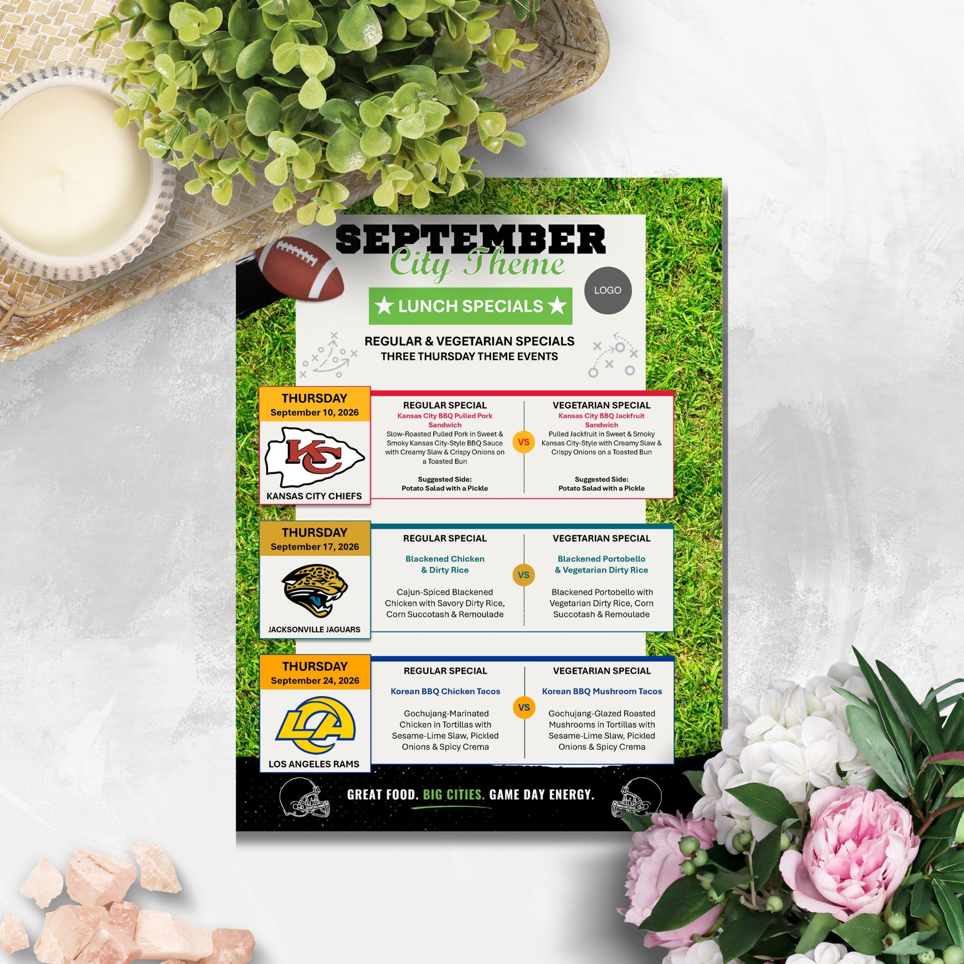 A printed September lunch specials sign styled on a white marble surface with a bowl of cream, green leaves, and pink flowers around it. The sign features team logos and text for Kansas City Chiefs, Jacksonville Jaguars, and Los Angeles Rams.