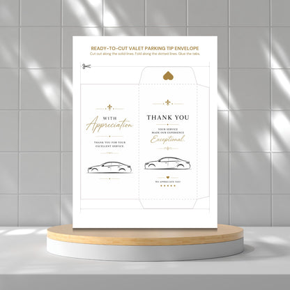 A printed ready-to-cut valet parking tip envelope template displayed upright on a round pedestal against a tiled wall. The envelope design is white with gold and black text and simple car line drawings.