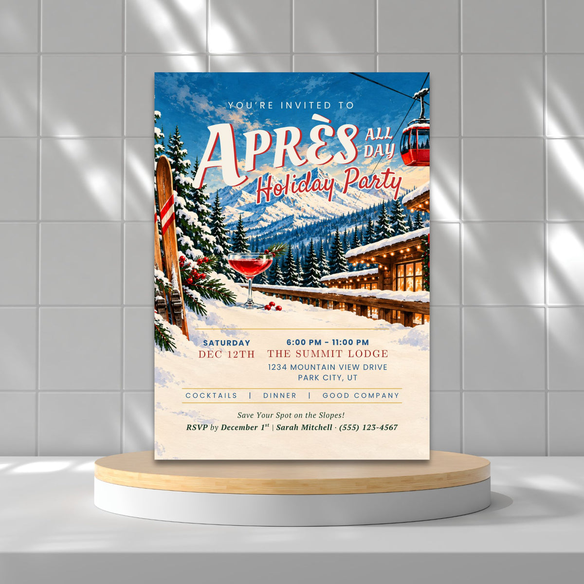 A winter-themed wedding save-the-date invitation card displayed on a round wooden pedestal against a gray tiled wall with soft shadows.