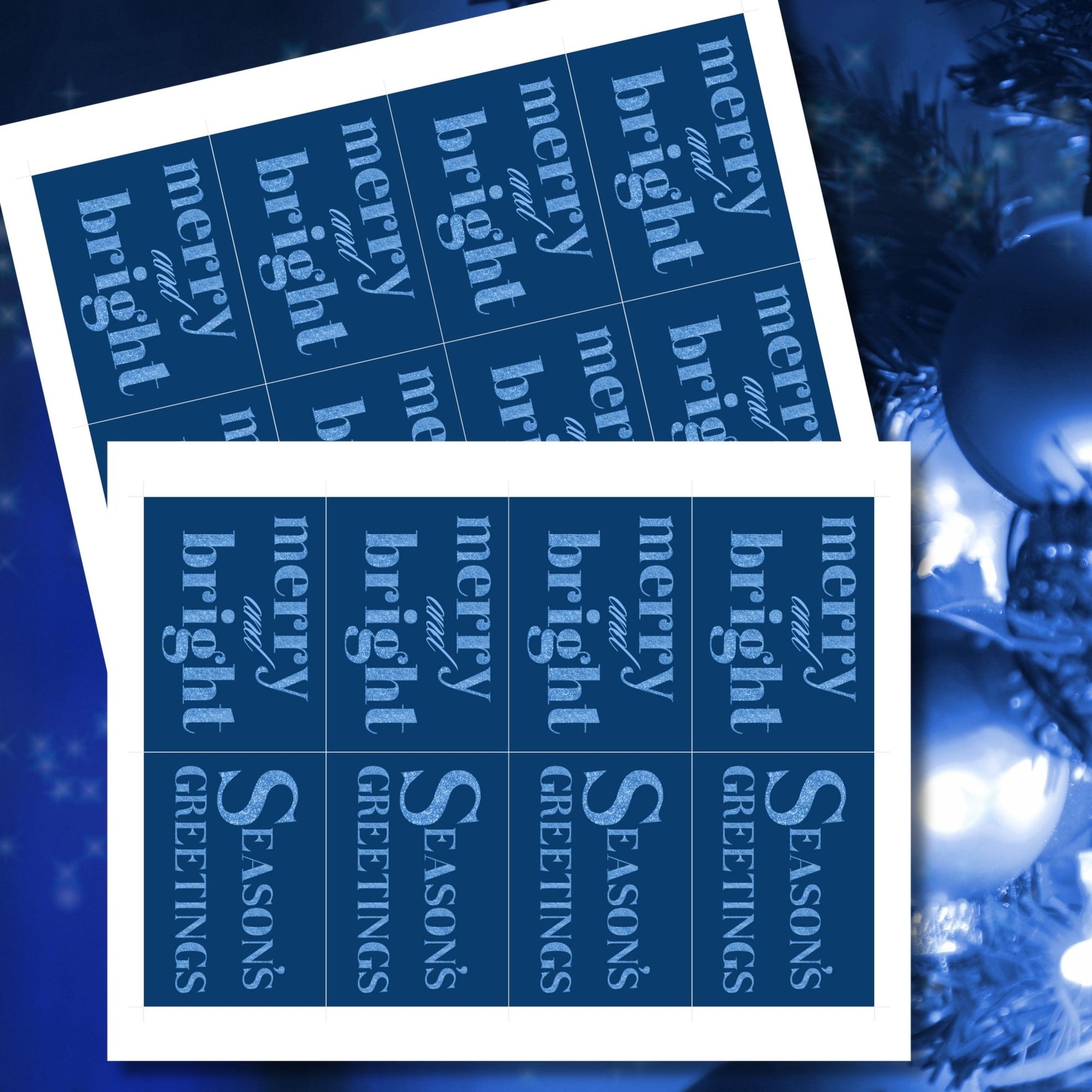 A set of ready-to-print Christmas gift tags featuring glittering icy blue text on a deep navy-blue background with festive messages like "Merry and Bright" and "Season's Greetings." Each tag is 2.5 x 3.5 inches, perfect for adding a frosty, elegant touch to holiday gifting.