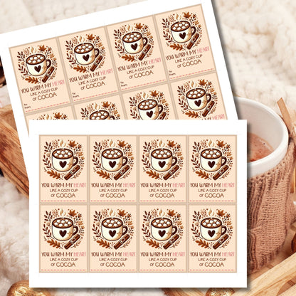 Editable hot cocoa-themed fall gift tags with the message 'You Warm My Heart Like a Cozy Cup of Cocoa' in 2.5 x 3.5 inches, 8 per sheet, available as printable and customizable PDFs.