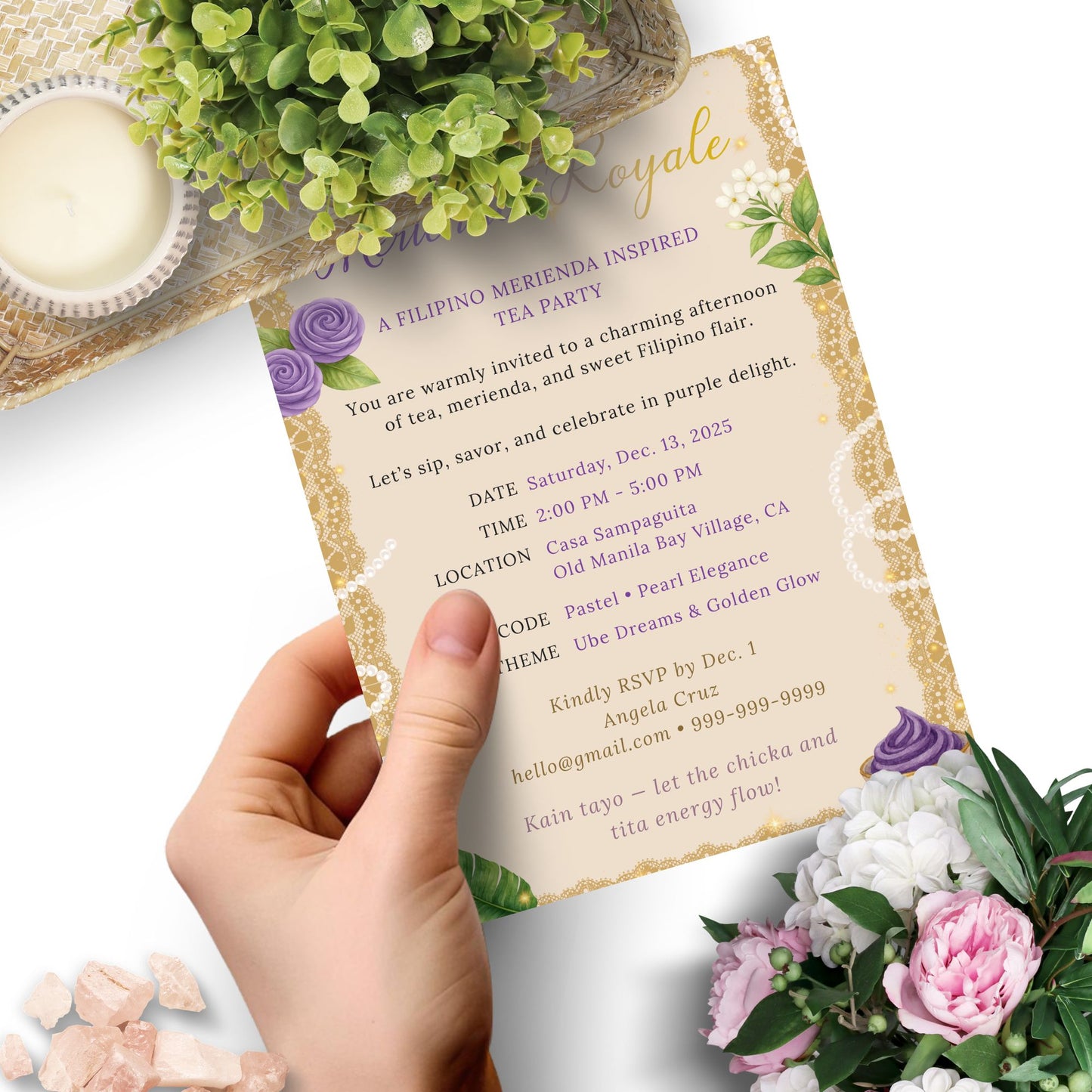 Invitation card held by a hand with floral decorations on a white background