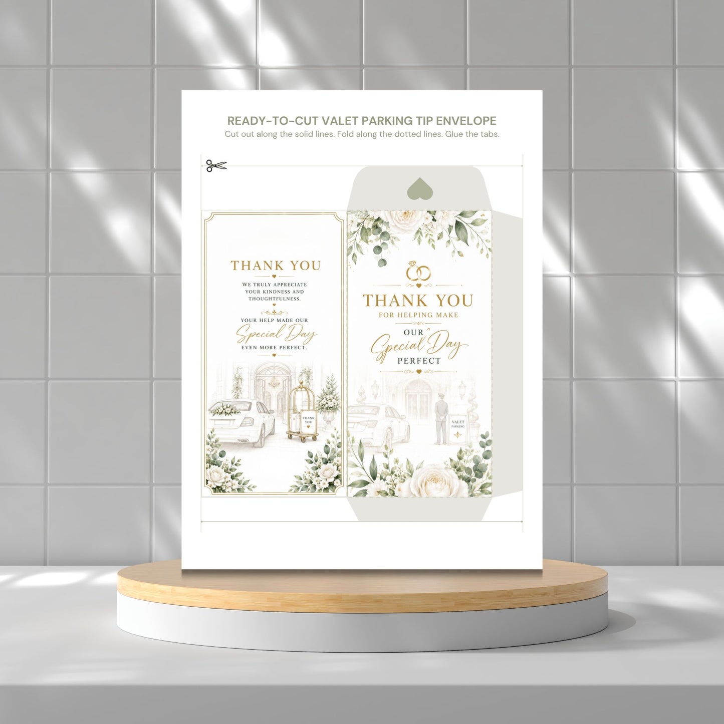 A printed valet parking tip envelope card set displayed upright on a round wooden-and-white pedestal against a light gray tiled wall. The card shows floral illustrations and elegant text reading 'THANK YOU' and 'Special Day Perfect.