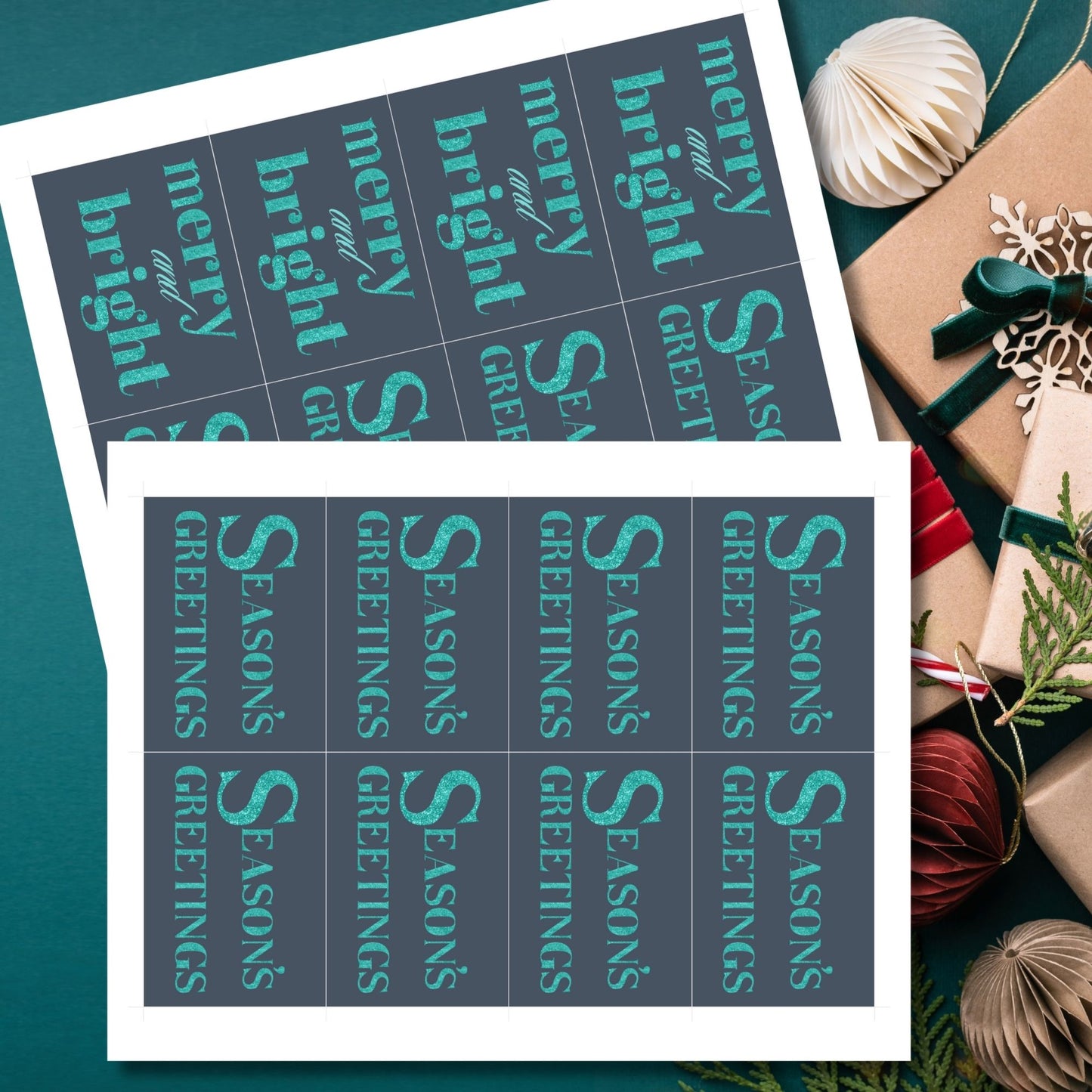 A set of ready-to-print Christmas gift tags featuring glittering turquoise text on a navy-blue background with festive messages like "Merry and Bright" and "Season's Greetings." Each tag is 2.5 x 3.5 inches, perfect for adding a vibrant touch to holiday gifting.