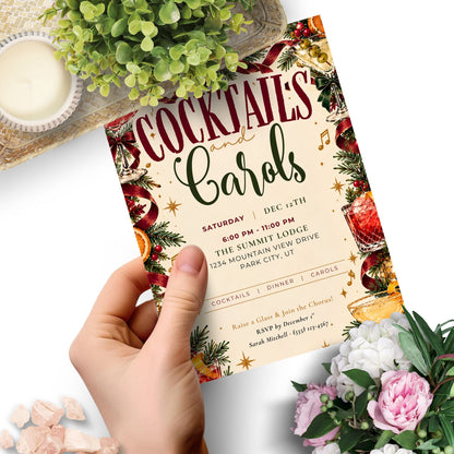A hand holds a decorative cocktail and carols event invitation card with festive red, green, and gold illustrations. The card features the text 'COCKTAILS and Carols' and event details.