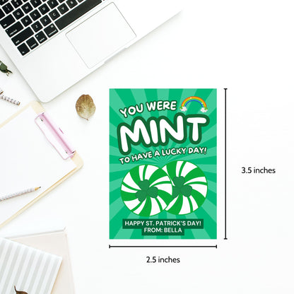 A fun St. Patrick’s Day printable gift tag featuring green peppermint swirls, a rainbow, and the pun "You Were MINT to Have a Lucky Day!" in bold, festive typography. The tags are 2.5 x 3.5 inches, laid out on an 8.5 x 11-inch sheet, 8 per page. Available as a printable PDF and an editable Canva template for personalization.