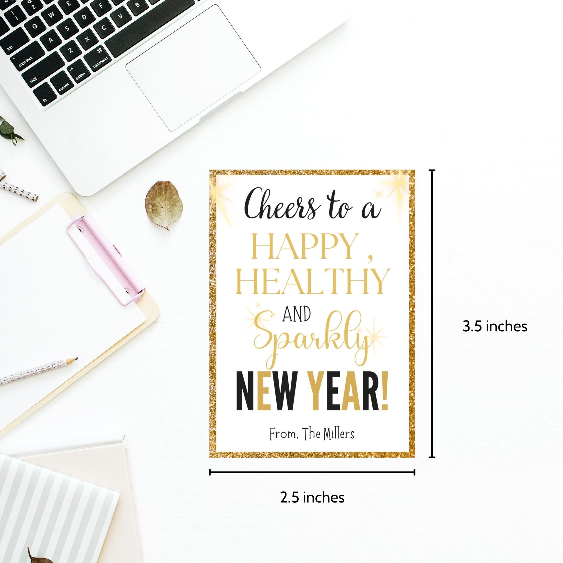 Gold and glittery editable printable New Year gift tags reading “Cheers to a Happy, Healthy, and Sparkly New Year!” laid out on an 8.5 x 11 sheet with 8 tags.