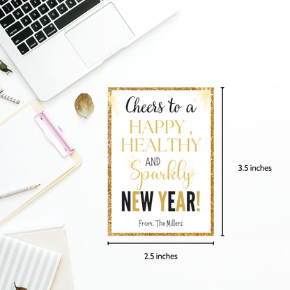 Gold and glittery editable printable New Year gift tags reading “Cheers to a Happy, Healthy, and Sparkly New Year!” laid out on an 8.5 x 11 sheet with 8 tags.