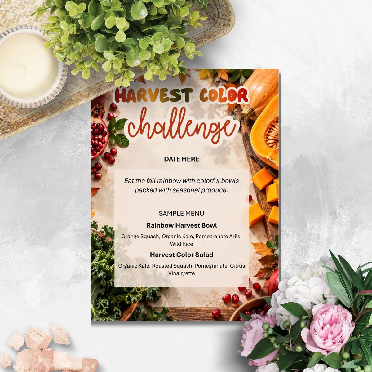 A printed 'Harvest Color Challenge' menu card styled in a flat lay with seasonal produce, flowers, and a small bowl on a light gray surface.