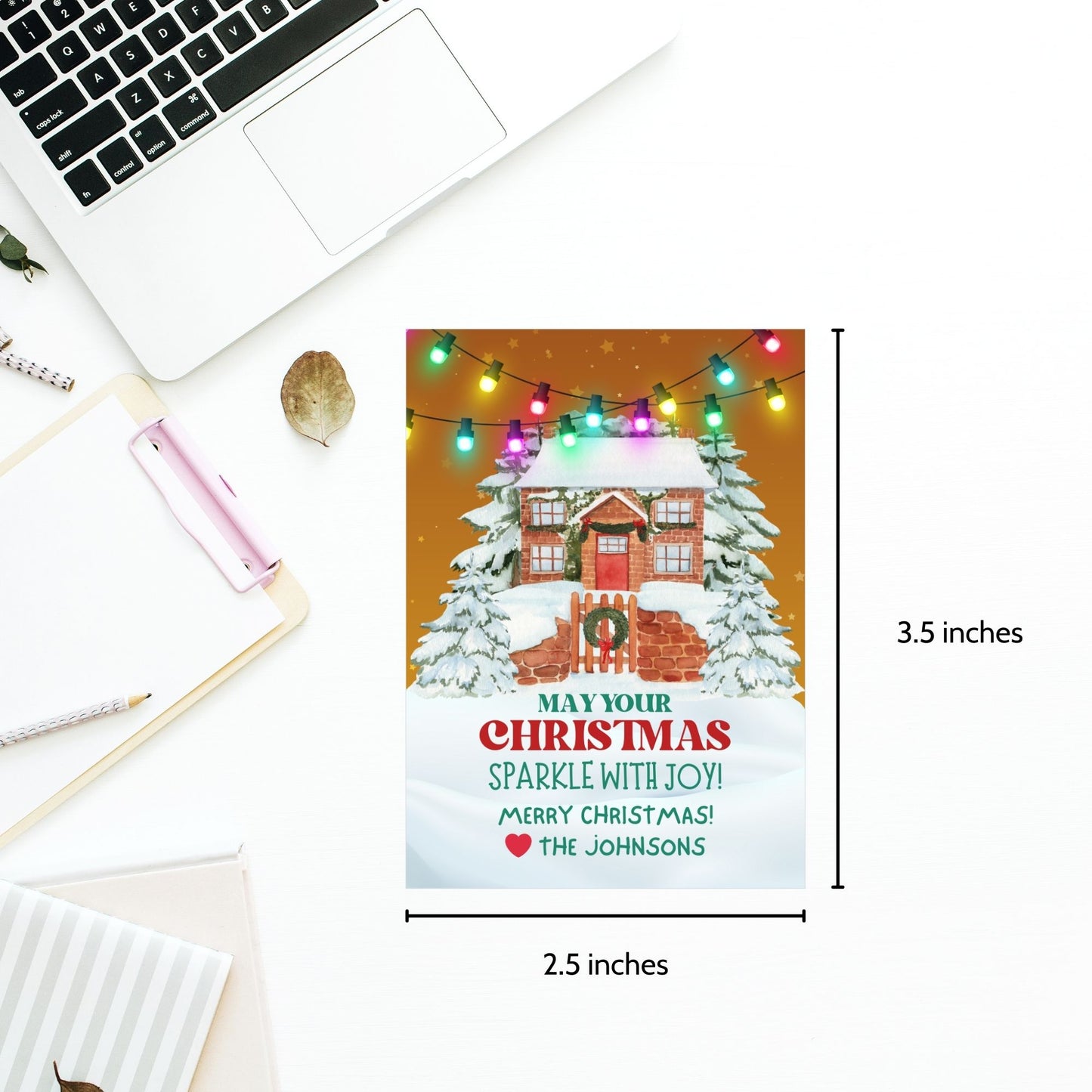 Christmas gift tags featuring a cozy snow-covered house decorated with festive lights, paired with the message "May Your Christmas Sparkle with Joy!" These printable and editable tags add a warm and festive touch to holiday gifts.