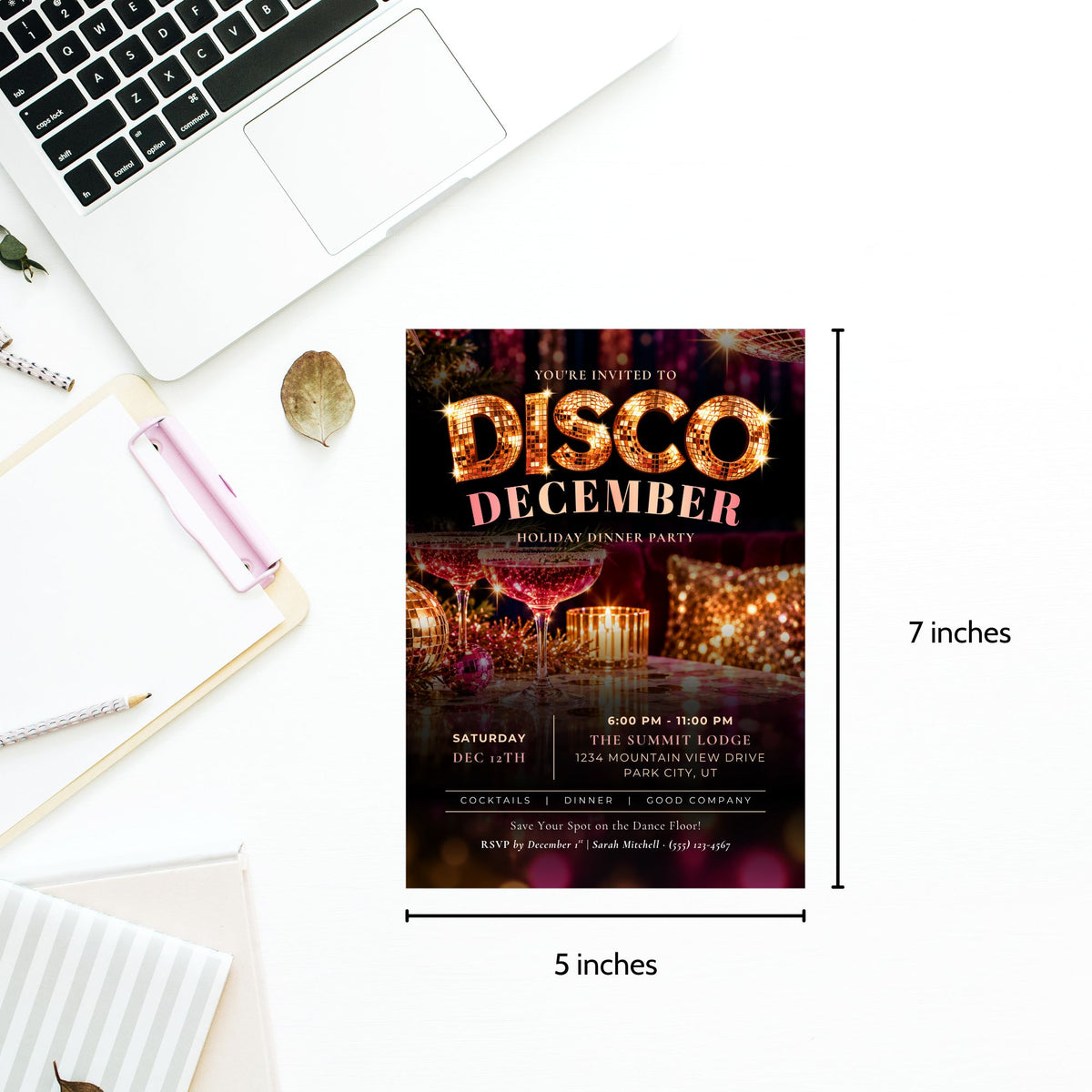 A 5x7 inch disco-themed birthday party invitation card shown on a white desk flat-lay with a laptop, notebook, and pen. The card features a dark background with warm orange and gold glittery text reading 'DISCO DECEMBER' and a blurred dancefloor scene.