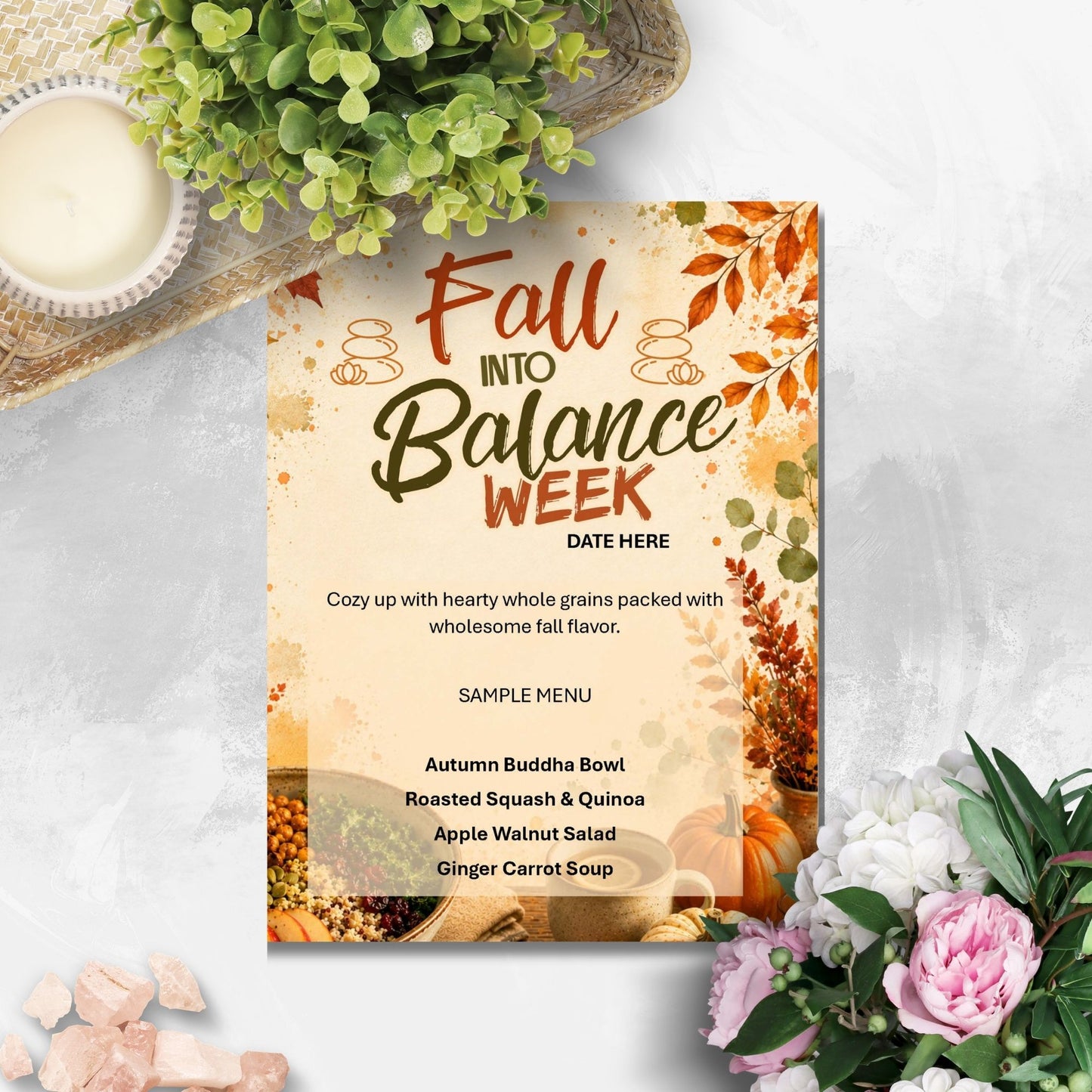 A fall-themed menu card reading 'Fall Into Balance Week' with a sample menu and autumn illustrations, styled on a light gray surface with flowers, greenery, and a candle around it.